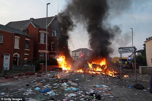 Southport burns: A street near a mosque goes up in flames as violent criminals took to the streets last night