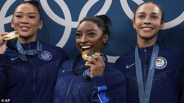 From left to right, Suni Lee, Simone Biles and Hezly Rivera celebrate winning the gold medal