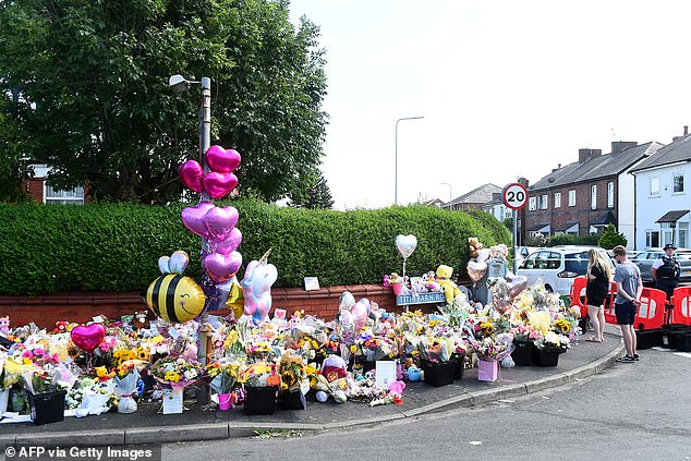 Today flowers, balloons and cuddly toys covered the street at the police cordon