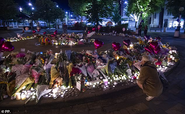 In stark contrast to the riots on the streets, there was a sense of calm at the site of the vigil as night fell