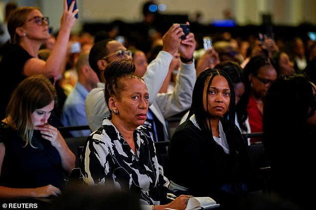 Congress attendees react during Donald Trump's interview at the National Association of Black Journalists (NABJ) convention