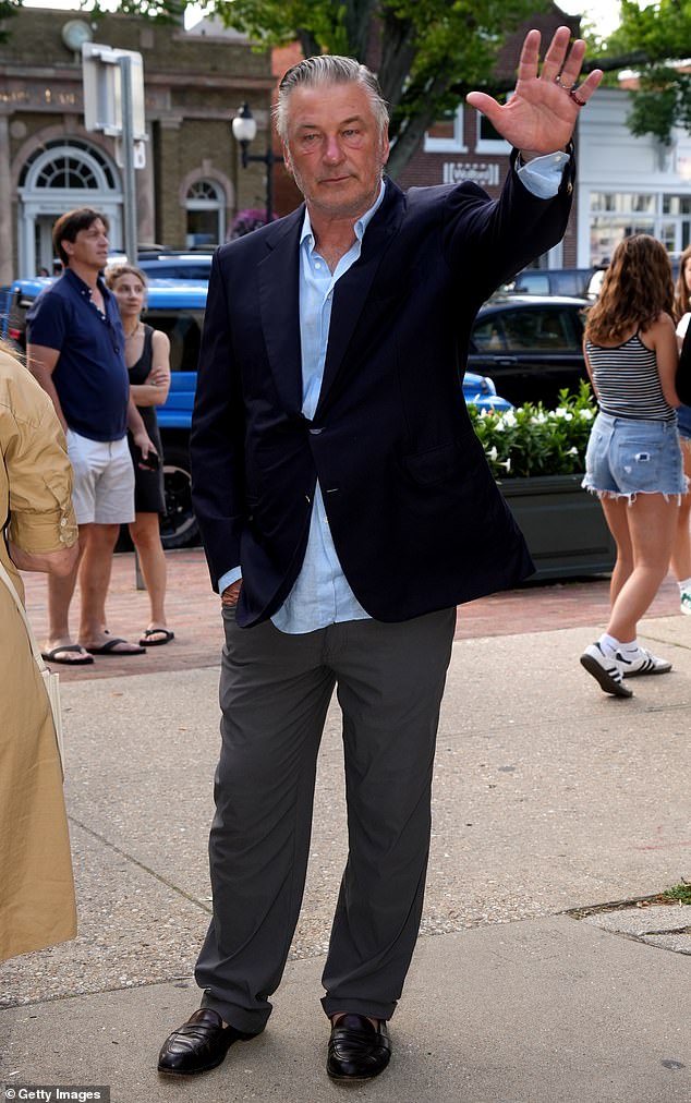 Baldwin was stylishly casual in dark gray pants, a light blue shirt and a black jacket over it