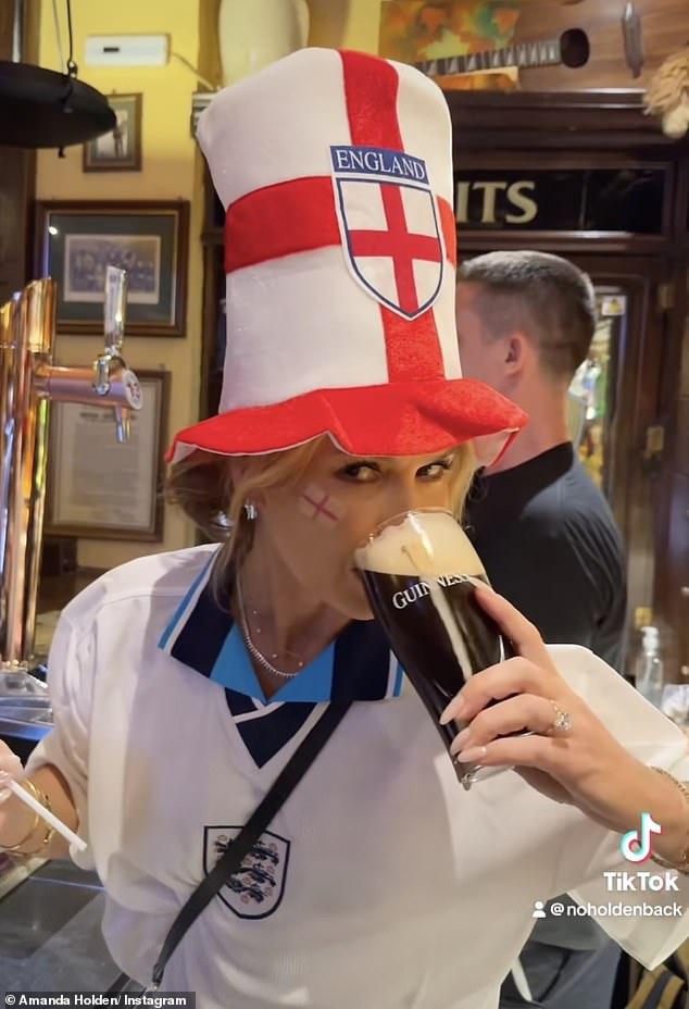 Amanda Holden, 53, drank a pint of Guinness in a football shirt and a new style of cap to cheer on England ahead of the thrilling Euro 2024 final in Spain on Sunday