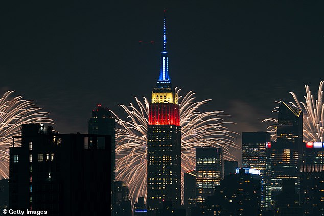 Macy's Fourth of July fireworks display lights up the night sky as a backdrop for the Empire State Building