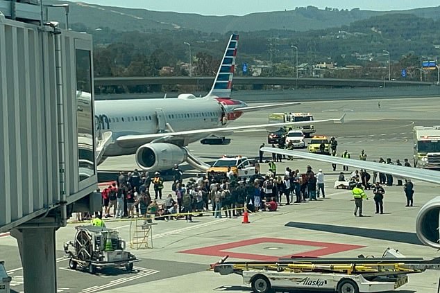 An American Airlines Airbus plane is evacuated at San Francisco International Airport on Friday after a fire broke out on board