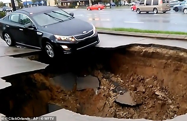 Central Florida has been dubbed 'Sinkhole Alley' after it became infamous for the dangerous phenomenon where the ground suddenly collapses. Pictured: A car being pulled into a sinkhole in Florida