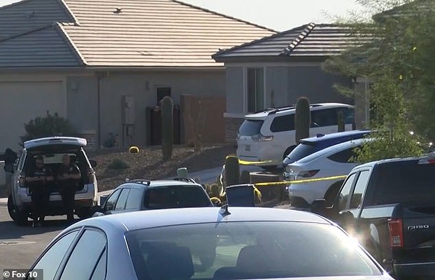 Police outside the home in Marana, north of Tucson, Arizona, on Tuesday evening while investigating the crime scene