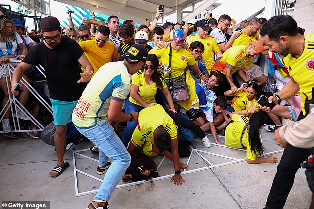 Colombia and Argentina fans try to pass through the gate amid mass unrest