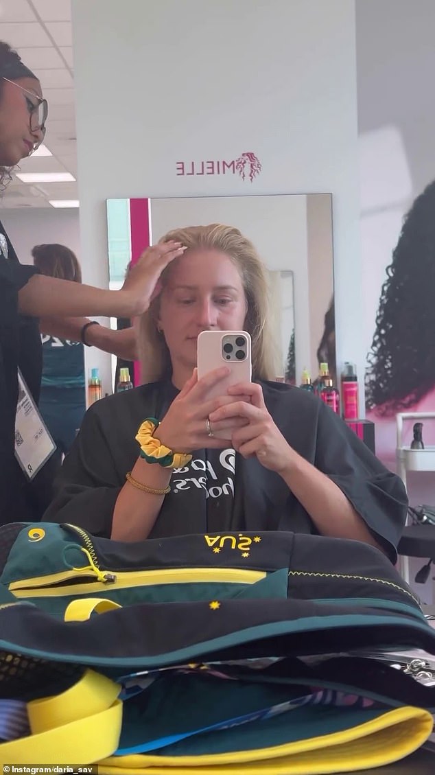 Australian tennis star Daria Saville enjoys a free haircut with her Olympic swag in front of her