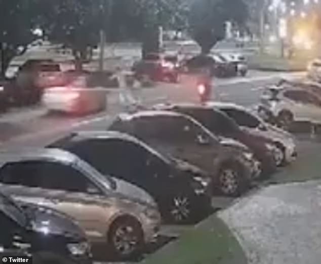 A surveillance camera shows Fabio Toshiro crossing the street before being hit by a BMW driven by Brazilian influencer Vitor Vieira on Saturday night in Rio de Janeiro