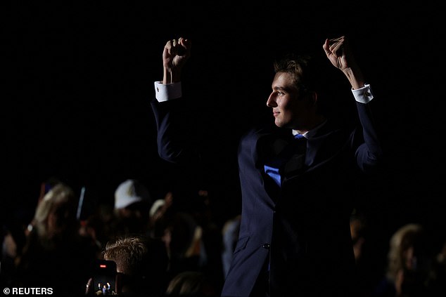 Barron Trump stands and pumps his fists as the crowd cheers at Tuesday night's Trump rally in Doral, Florida. Former President Donald Trump noted that the 18-year-old 