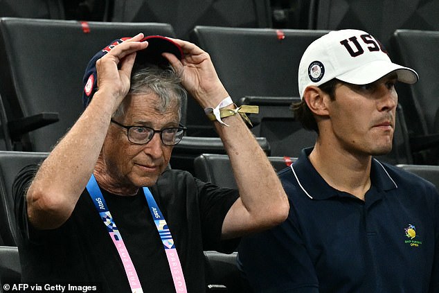 Bill Gates, 68, was seen wearing a black T-shirt and a navy and red American baseball cap as he watched intently the women's artistic gymnastics team final during the Paris 2024 Olympic Games on Tuesday