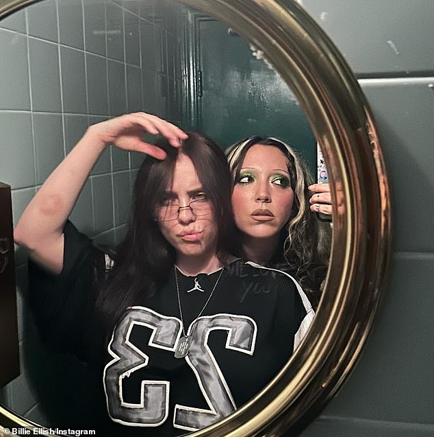 In another photo she posed with a friend in front of a mirror