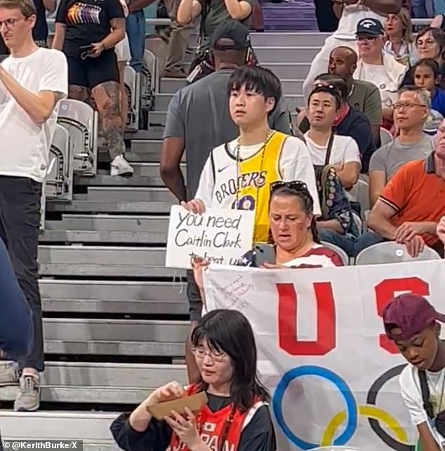 The fan held up a sign reading 'you need Caitlin Clark to beat us' before their match against Japan