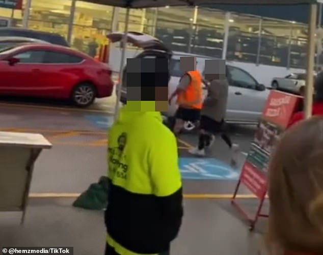 Several customers and staff members were heard yelling abuse at the men (pictured in the center) as they reportedly tried to grab the power tools from a cart