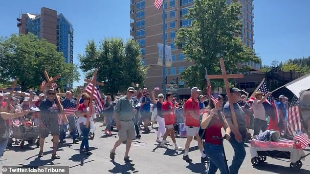 Those attending the Independence Day Parade in Coeur d'Alene in the deep red state could be seen proudly waving crosses alongside the star-spangled banner