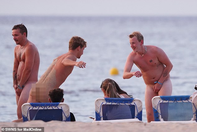 Tourists show their buttocks on the beach in Spain