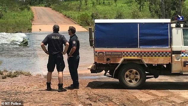 NT police officers near the area where the girl disappeared. Her remains were found after a 36-hour search by land, air and water