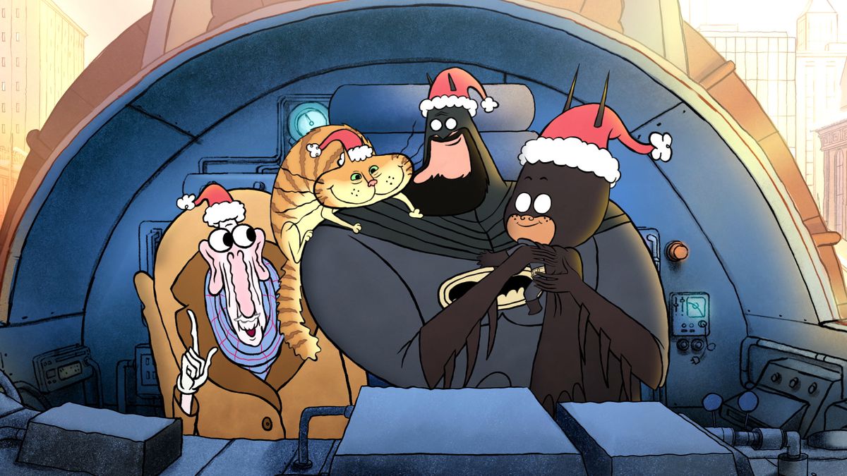 Batman, Damian Wayne in a child's Batman costume, a cat and Alfred gather in the Batwing cockpit wearing Santa hats in the cheerful Little Batman