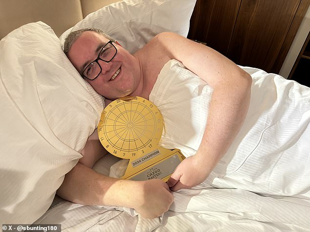 Bunting celebrated his Masters title success by having a photo taken with the trophy in bed
