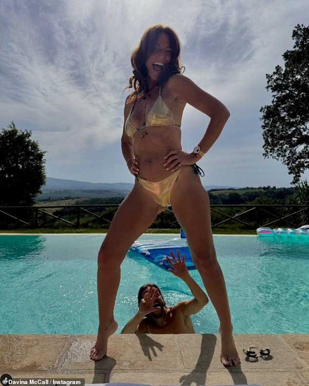 Davina McCall showed off her toned body in a skimpy gold bikini as she posed by the pool in a new Instagram photo on Tuesday