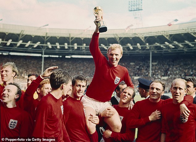 England captain Bobby Moore holds up the World Cup (Jules Rimet Trophy) with his teammates at Wembley Stadium, 30 July 1966