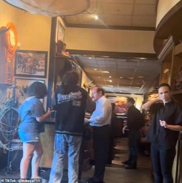 An unknown man and woman were caught trying to leave a LongHorn Steakhouse restaurant before realizing she had left her purse behind