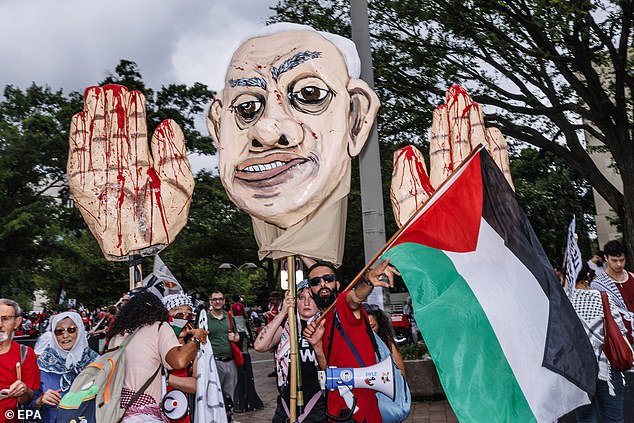 Protesters hold a bloodied effigy of Benjamin Netanyahu ahead of his speech to Congress