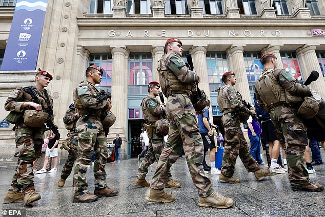 French soldiers patrol outside Gare du Nord station in Paris after a 'coordinated' attack on rail infrastructure on Friday