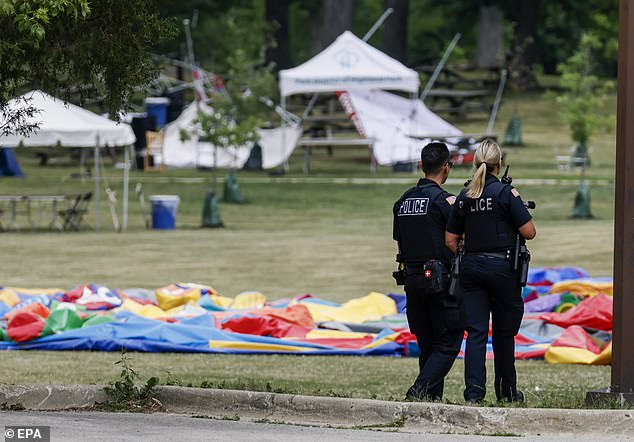 Police officers guard a park near the scene of a mass shooting during a July 4 celebration and parade in Highland Park, Illinois, in 2022