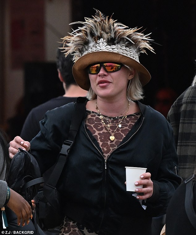 Florence Pugh got into the festival spirit by wearing a quirky brown feathered hat on the final day of Glastonbury on Sunday
