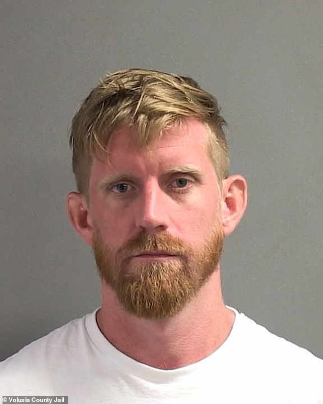 Brandon Gilmore, 31, was arrested Saturday after allegedly dangling the child from a second-floor balcony at the Sandlewood Resort in Daytona Beach