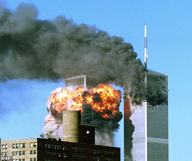 Smoke rises from the top of One World Trade Center and flames and debris explode from Two World Trade Center, Tuesday, September 11, 2001