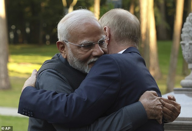 Indian Prime Minister Narendra Modi, left, and Russian President Vladimir Putin embraced during an informal meeting yesterday