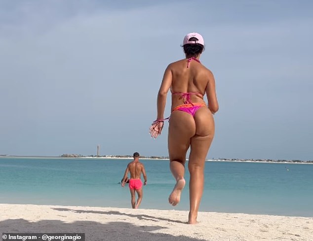 Georgina showed off her incredible figure as she chased Cristiano into the sea, both wearing pink swimsuits