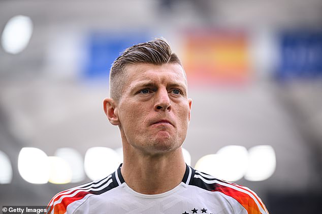 German midfielder Toni Kroos (pictured on July 5 in Stuttgart) has said 'uncontrolled' immigration has made his home country unrecognisable and believes his daughter is safer in Spain