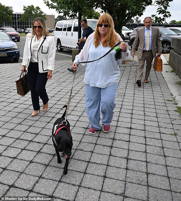 Heuermann's ex-wife Asa Ellerup was seen wearing her wedding ring while walking Stewie, the family's service dog, and her attorney Robert Macedonio and another member of Ellerup's legal team were seen walking nearby as they made their way to the entrance of the Suffolk County Courthouse.