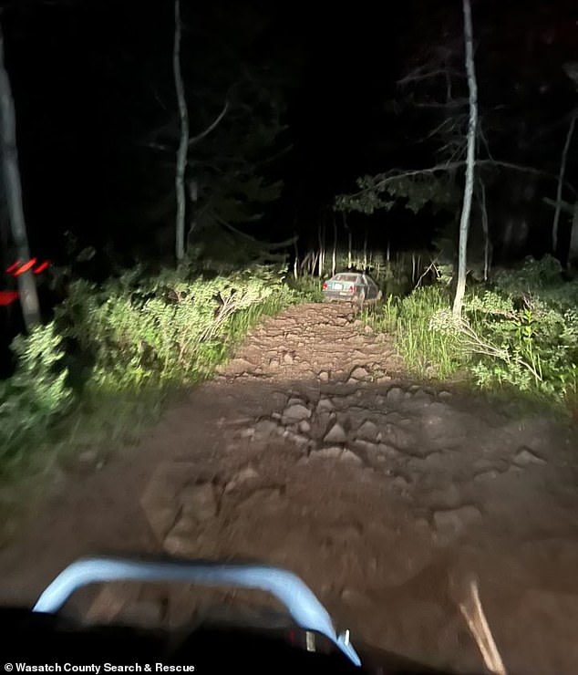 Images captured by rescue teams show the blue vehicle on a rocky dirt track, with teams having to use all-terrain vehicles to reach the driver