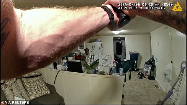 Deputy Sheriff Sean Grayson's gun drawn as Sonya Massey takes cover in her kitchen on July 6