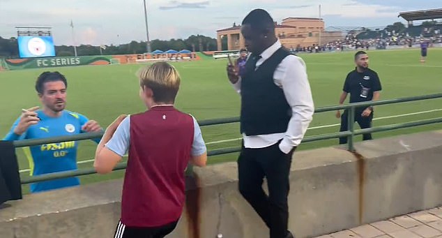 Jack Grealish (left) was seen in a heartwarming clip on social media greeting an Aston Villa fan and signing his shirt