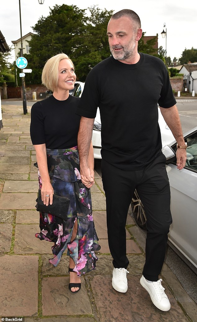 Stephanie looked effortlessly chic in a black top which she paired with a high-waisted floral wrap skirt, giving a glimpse of her tinted pins