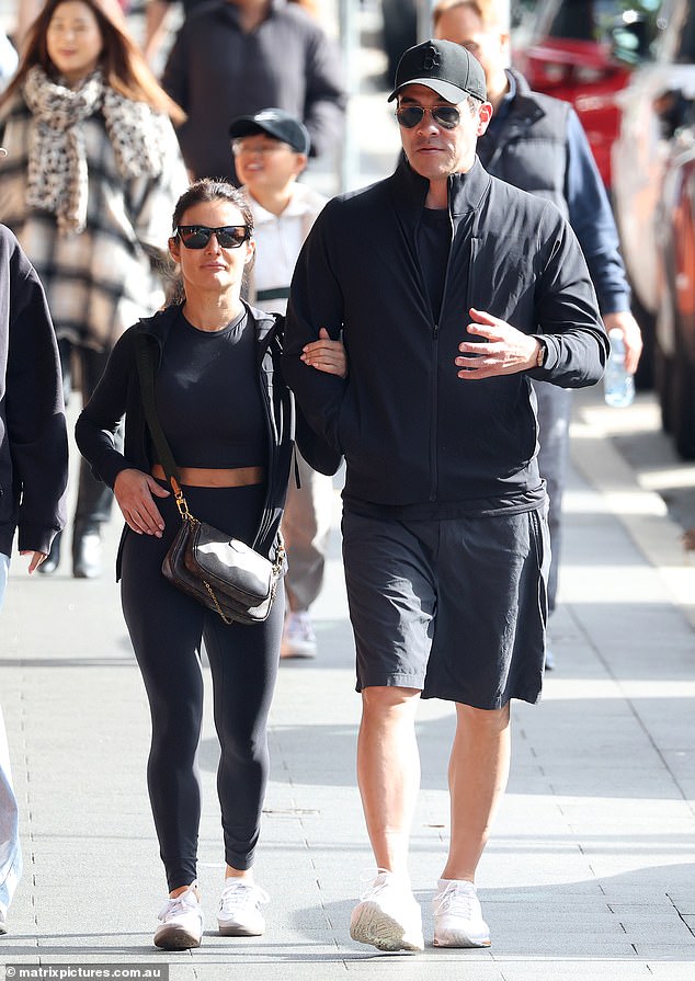 James Stewart, 48, (right) and Ada Nicodemou, 47, (left) looked on as the loved-up couple took a sunny stroll in Coogee on Saturday