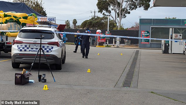 Evidence markers have been placed in the 7-Eleven parking lot