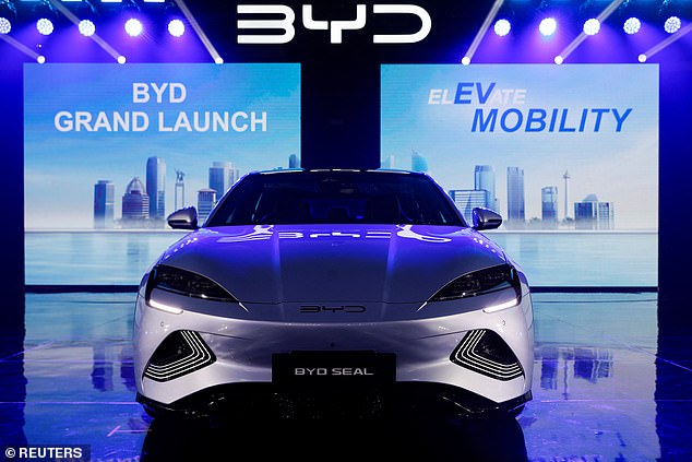 Australia could be making electric cars instead of importing them from China if it hadn't made a major blunder a decade ago, says a former minister (pictured with a BYD stamp)