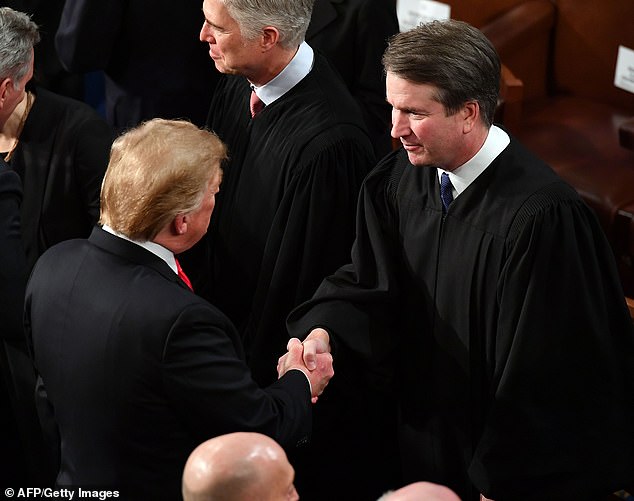 Justice Brett Kavanaugh shakes hands with President Donald Trump before the 2019 State of the Union address. It was his whirlwind confirmation that helped propel Vance into politics