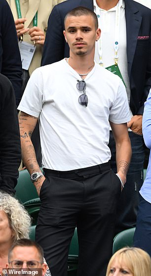 Romeo Beckham looked the spitting image of his famous father David as he was spotted cheering on Emma Raducanu on the third day of Wimbledon (pictured)