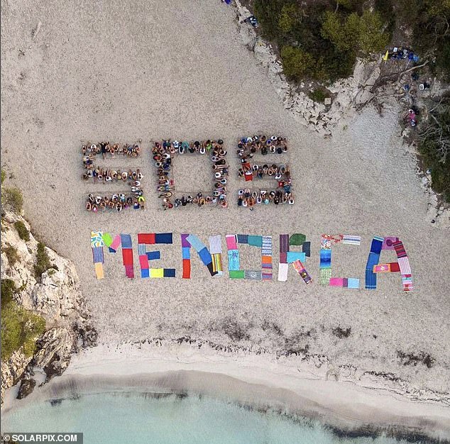 Hundreds of protesters have blocked tourist access to a postcard-perfect Menorcan beach called Cala Turqueta