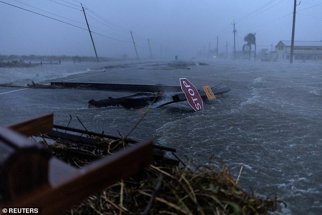 Debris and floodwaters from Hurricane Beryl cover the main road in Surfside Beach, Texas on July 8, 2024