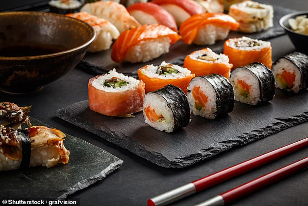 Pictured: File photo of various types of sushi served on a black stone