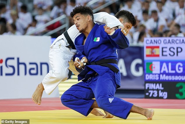 Israel has accused disqualified Algerian fighter Redouane Messaoud Dris (above, in blue) of deliberately missing a weigh-in to avoid fighting their judoka Tohar Butbul at the Paris Olympics.